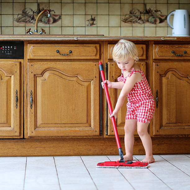 istock Little girl mopping floor in kitchen 519052815