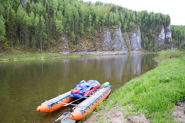inflatable catamaran on water on background of rocks, beauty