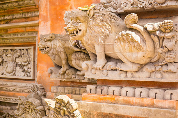 Lions carved in stone Lions carved in stone at the entrance to a Hindu temple. The door is fully decorated with oriental motifs and designs in gold. palazzo antico stock pictures, royalty-free photos & images