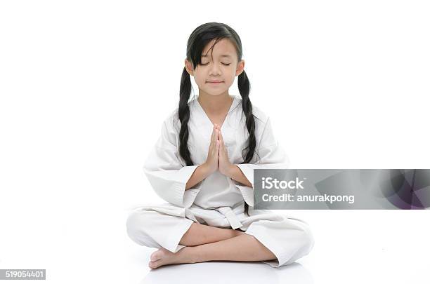Little Asian Girl In White Kimono Meditating On White Background Stock Photo - Download Image Now