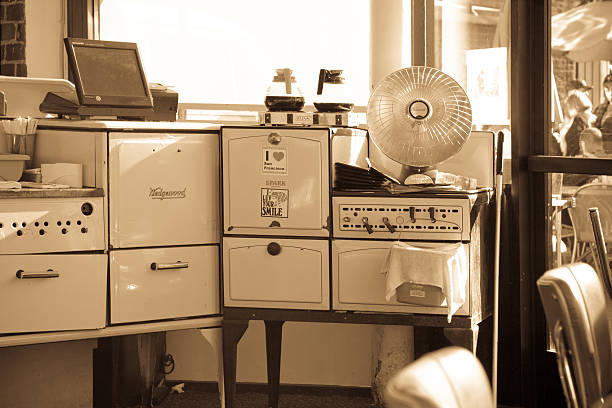 Nostalgic kitchen equipment San Francisco, USA - April 13, 2014: Sepia toned image of 1950s kitchen equipment in a shop window in San Francisco California. The scene include the incongruous LCD screen in the top left. retro 1950s kitchen stock pictures, royalty-free photos & images