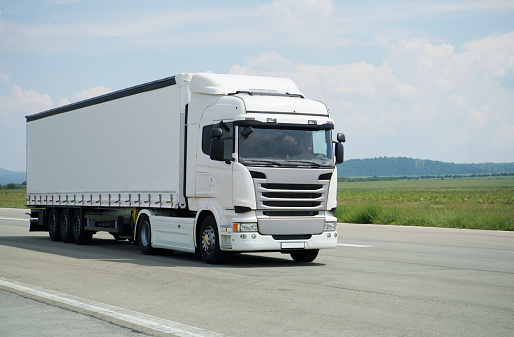 White semi-truck on a highway.