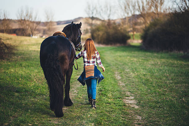 istock young womanwalking with horse 519077734