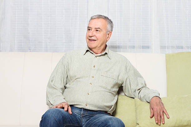 istock Happy senior man sitting on sofa 519077976