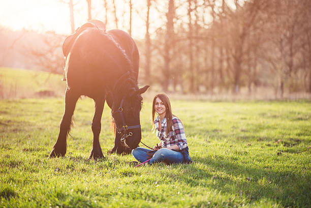istock young woman with horse in spring sun nature 519078112