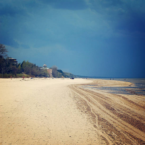 Sandy dunes and Baltic sea - vintage effect. Empty Jurmala beach out of season - toned photo. Spring seascape - retro filter. Jurmala, Latvia.