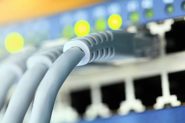 Network Connection Plug High tech network cables in a server. broadband isp stock pictures, royalty-free photos & images