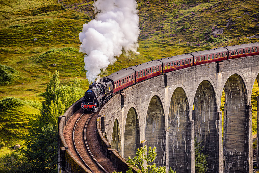Glenfinnan, Scotland, United Kingdom - September 9, 2015 : Glenfinnan Railway Viaduct in Scotland with the Jacobite steam train passing over