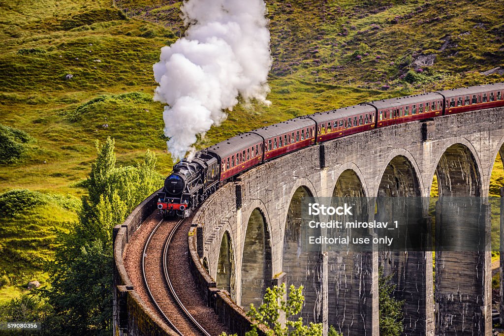 Glenfinnan Railway Viaduct in Scotland with a steam train Glenfinnan, Scotland, United Kingdom - September 9, 2015 : Glenfinnan Railway Viaduct in Scotland with the Jacobite steam train passing over Harry Potter Stock Photo