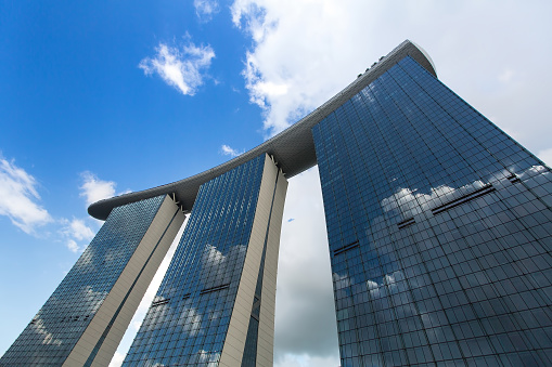 Singapore, Singapore - February 18, 2016: Marina Bay Sand hotel against blue sky background. Developed by Las Vegas Sands, it is billed as the world's most expensive standalone casino property at S$8 billion, including the land cost.