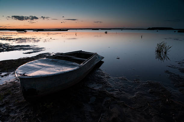istock boat on the lake at sunset. 519083548