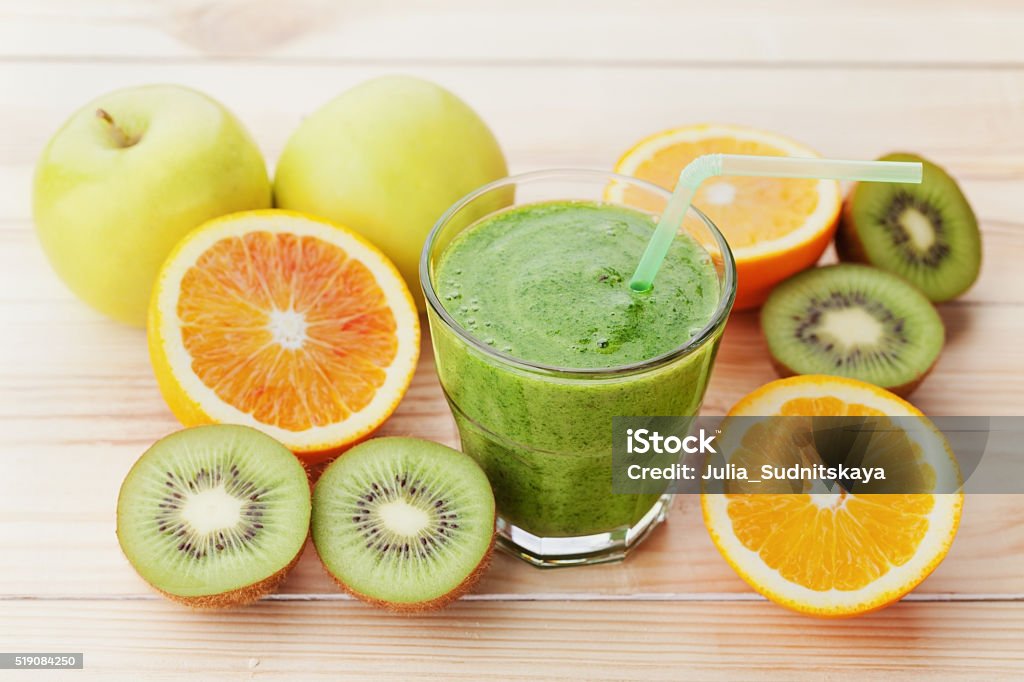 Smoothie or juice, detox and diet food, healthy breakfast Green smoothie or juice in glass on wooden table, detox and diet food, healthy breakfast Kiwi Fruit Stock Photo