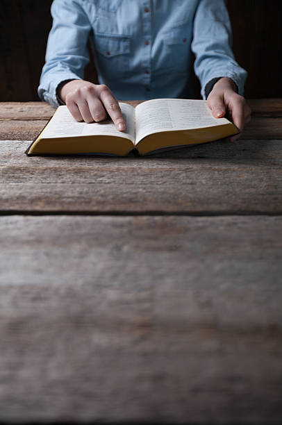 istock woman hands on bible 519088768