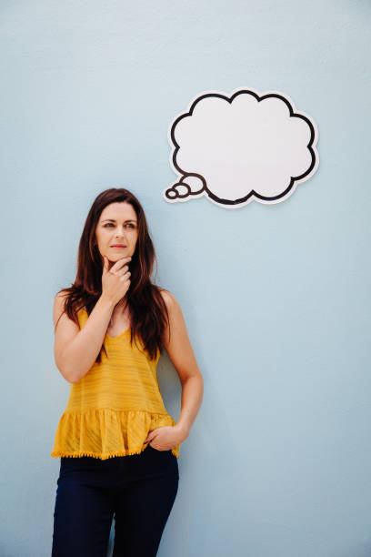 istock Pensive pretty woman looking up 519088884