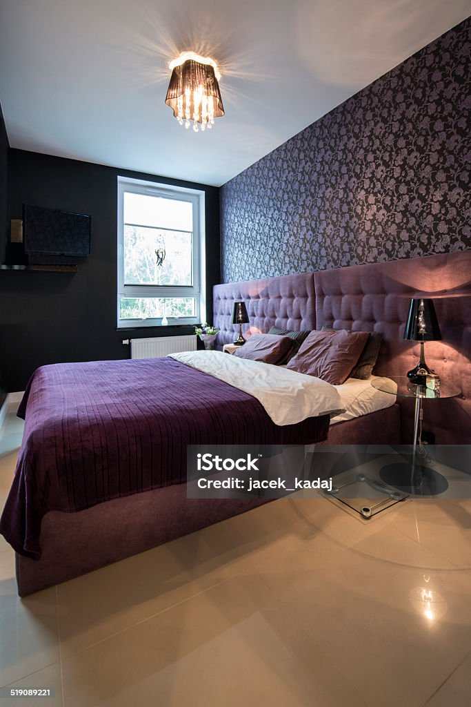 Modern bedroom Modern bedroom in dark, violet design Apartment Stock Photo