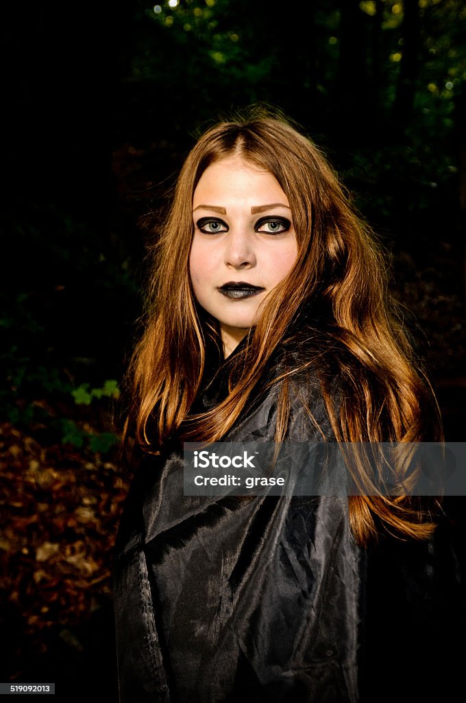 Girl in forest Pretty young girl with black make up portrait in forest Goth Stock Photo