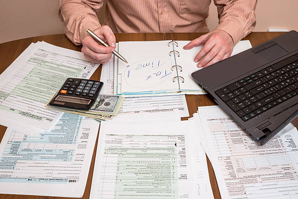 istock Filling 1040 tax form wtih laptop 519092130