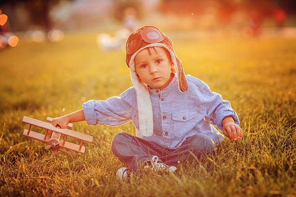 istock Cute boy, playing with airplane on sunset in the park 519092177