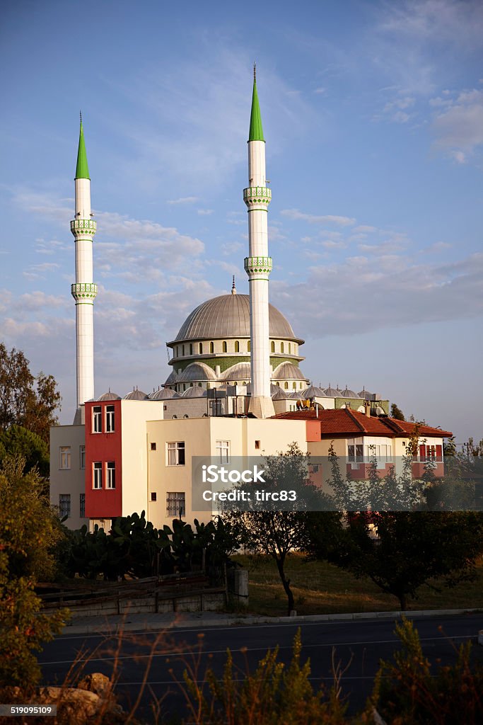 Turkish mosque with twin green spires Blue Stock Photo