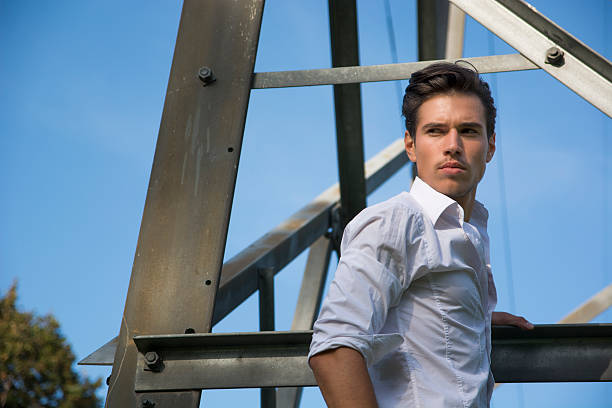 istock Handsome young man hanging from metal electricity trellis 519107345