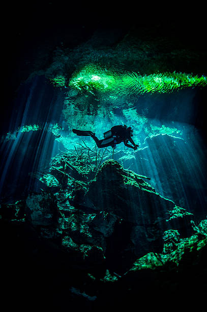 Mexico cenotes Scuba diver exploring the underwater caves. puerto aventuras stock pictures, royalty-free photos & images