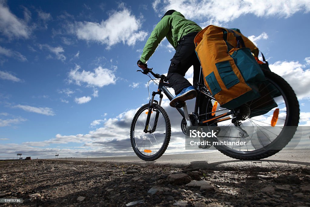 Tourist Bicycle tourist with loaded bike riding on an empty road Bicycle Stock Photo