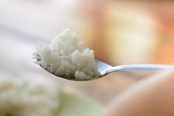 Rice in spoon closeup. stock photo
