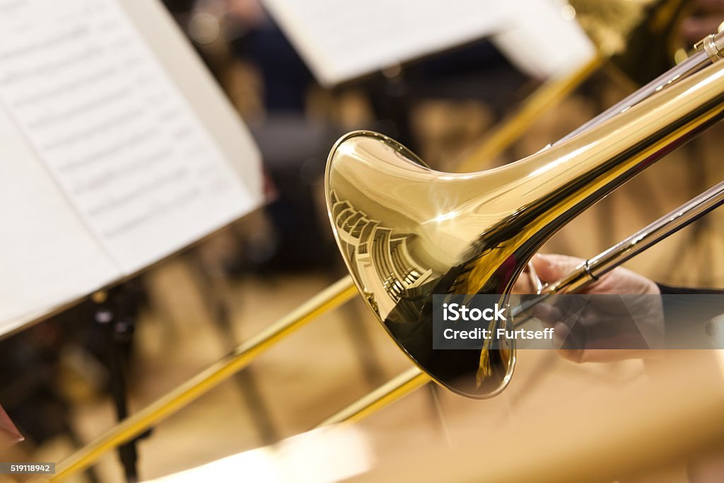 Detail of a trombone  Detail of a trombone in the hands of the musician closeup Trombone Stock Photo