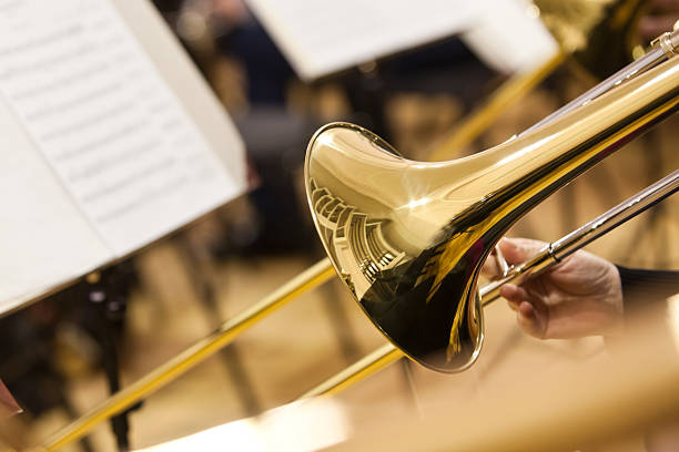 Detail of a trombone  Detail of a trombone in the hands of the musician closeup classical orchestral music stock pictures, royalty-free photos & images
