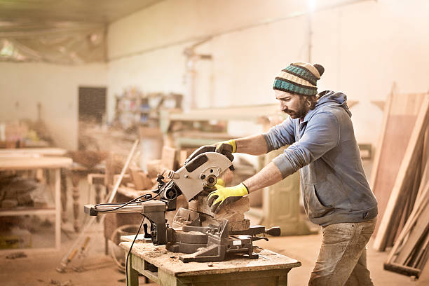 istock Man cutting wood with circular saw 519121596