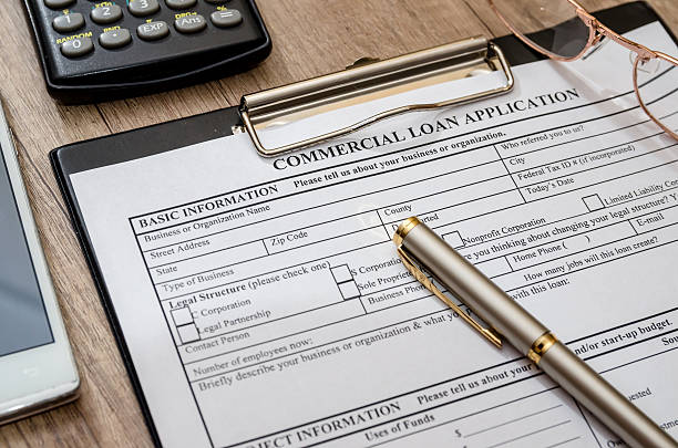 istock File the commercial loan application with calculator, pen on desk 519122774