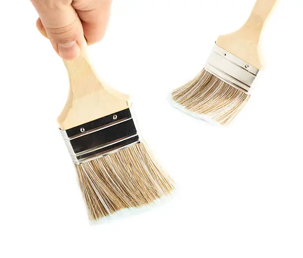 Photo of Hand holding a wide brush