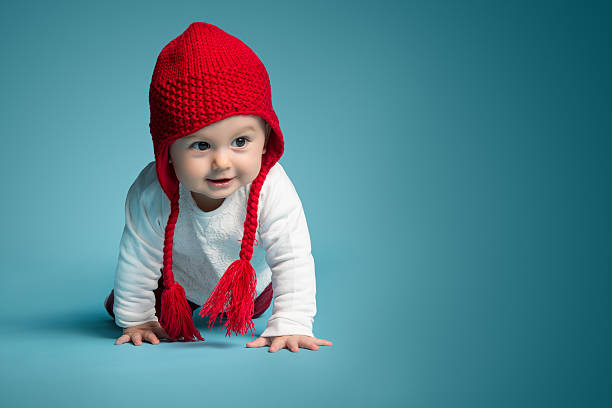 счастливый мало babby - front view female isolated on red happiness стоковые фото и изображения