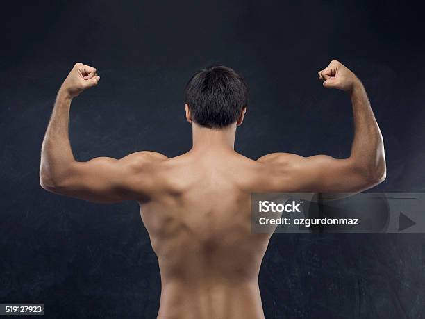 Muscular Men Showing His Back Muscles Stock Photo - Download Image Now - Adult, Adults Only, Anaerobic Exercise
