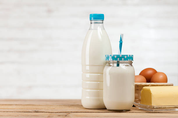 istock Milk bottle on wooden table 519127976