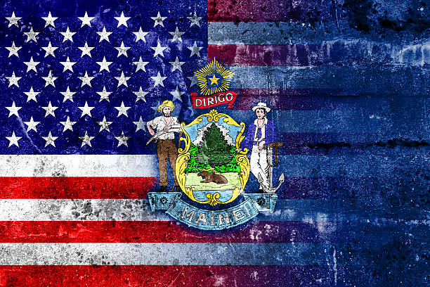istock USA and Maine State Flag painted on grunge wall 519128281