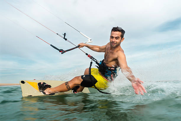istock Man surfing and splashing to the camera 519128884