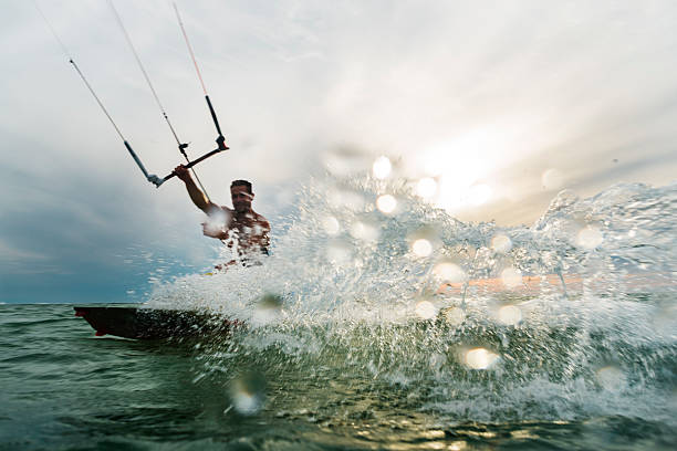 istock Man surfing and splashing to the camera 519129088