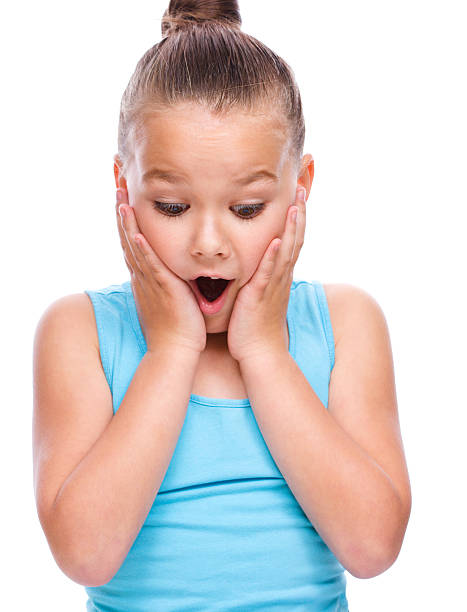 istock Cute girl is holding her face in astonishment 519129421