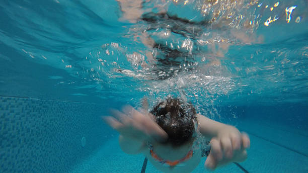 istock boy underwater in a swimming pool 519129682