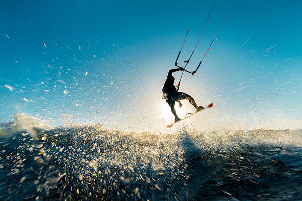 surfer-jumping in den sonnenuntergang - wakeboarding stock-fotos und bilder
