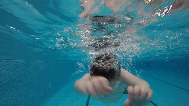 istock boy underwater in a swimming pool 519131366