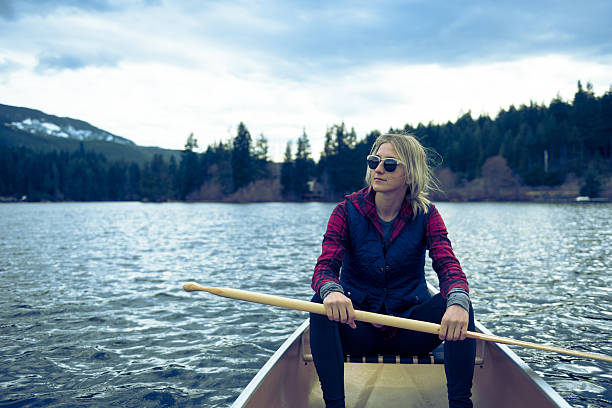 istock Female canoeing on a prisitine lake 519131586