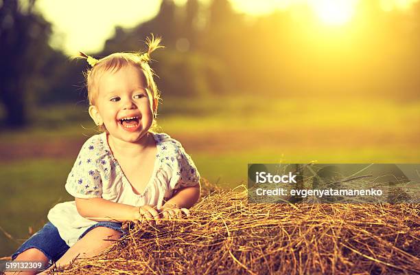 Happy Baby Girl Laughing On Hay In Summer Stock Photo - Download Image Now - Baby - Human Age, Baby Girls, Beautiful People