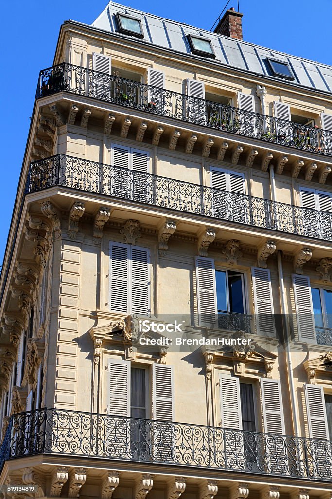 Old School Ironwork Ornate buildings in Paris. Apartment Stock Photo