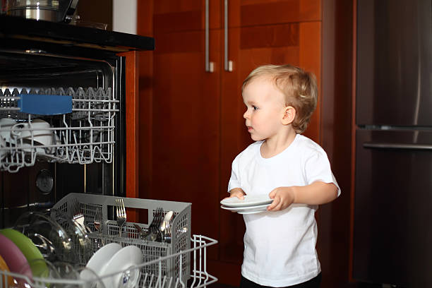 istock Little boy with plates near dishwasher 519154502