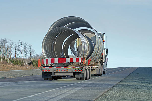 istock Semi Flatbed Truck Hauling Large Diameter Pipe Sections 519156382