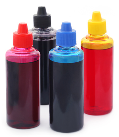 Printer ink bottles over white background