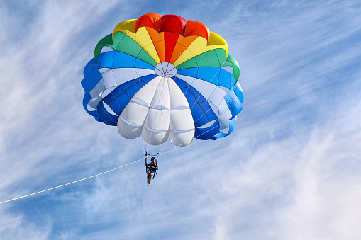 Tucson, Arizona, USA - March 24, 2023: A parachutist with the Red Bull Air Force lands at the 2023 Thunder and Lightning Over Arizona airshow.