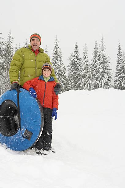 istock Father and son with snow tube 519161886